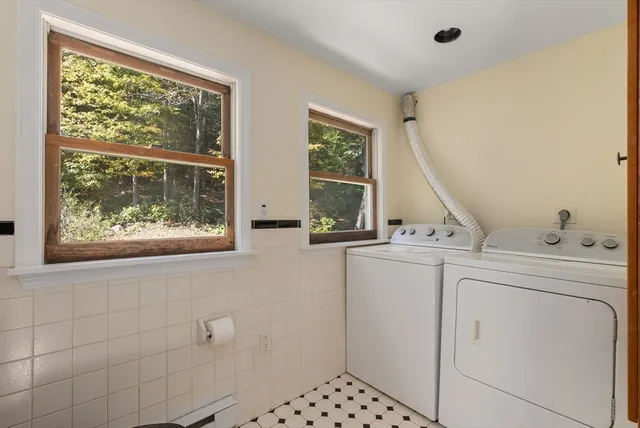 a front view of a house with a tree