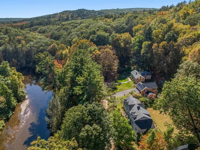 an aerial view of residential house with yard and swimming pool