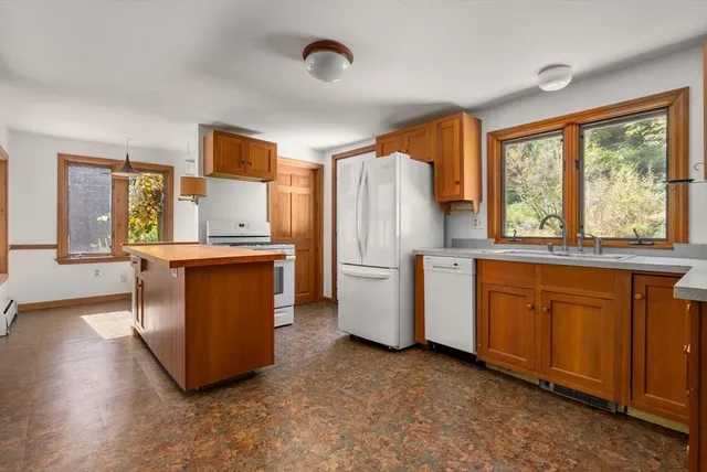 an aerial view of a house with a yard and trees