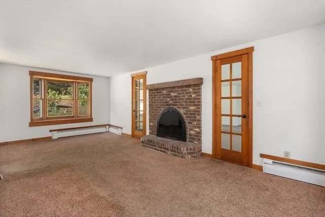a living room with furniture large window and a fireplace