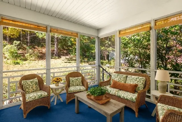 a spacious bedroom with a bed and glass door