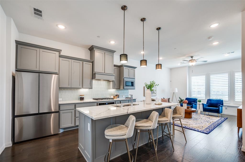 3718 Pelican Rst Way Arlington, TX 76005 - Photo 5 of 37 a kitchen with stainless steel appliances granite countertop a refrigerator a sink a stove a dining table and chairs