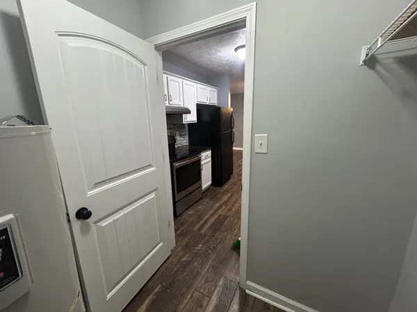 a view of a hallway with wooden floor