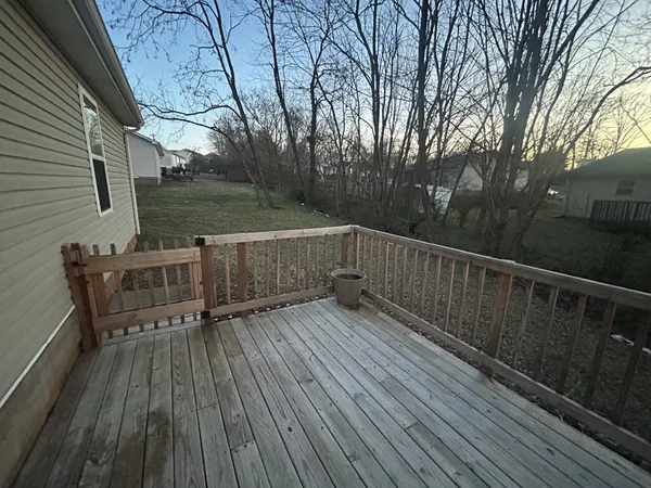 a view of deck with wooden floor and fence