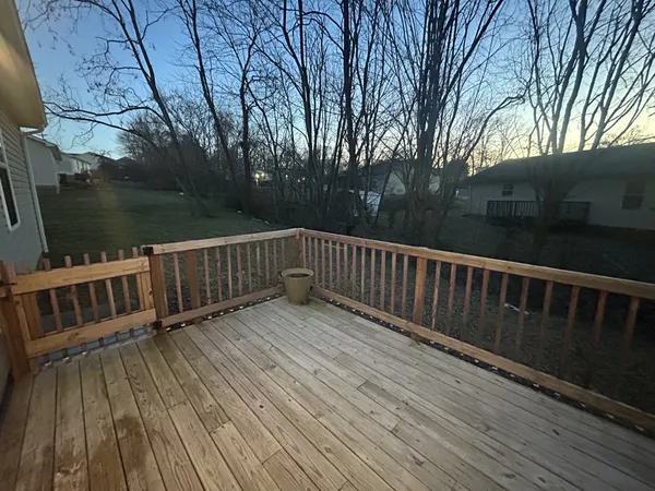 a view of deck with wooden floor and fence