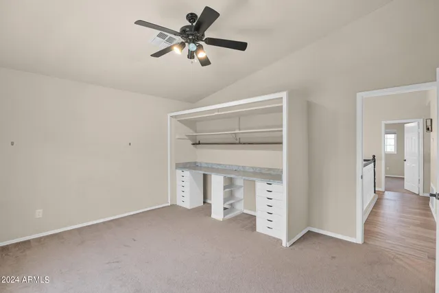 a view of an empty room with a fan