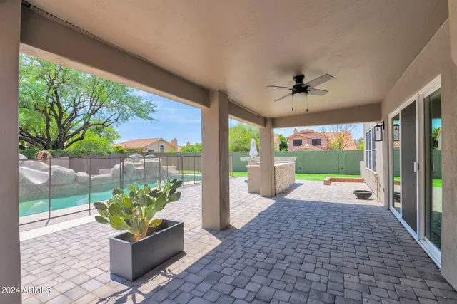 a porch with a table and chairs