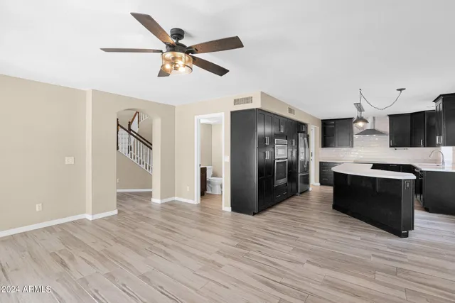 a view of a kitchen with a sink and a refrigerator