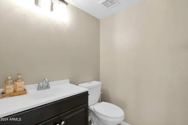 a white toilet sitting next to a bathroom sink