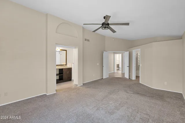 a view of a livingroom with a ceiling fan & entryway