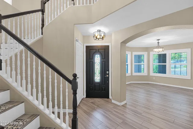 a view of an entryway with wooden floor
