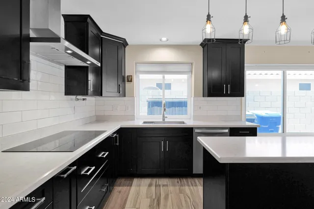 a kitchen with a sink a stove and cabinets