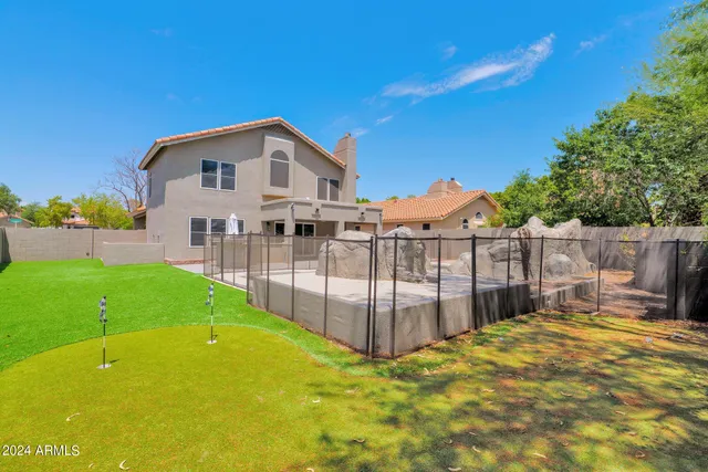 a view of a house with a backyard and a patio