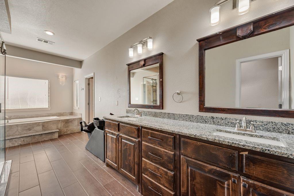 461 Pearson Ranch Road Azle, TX 76020 - Photo 22 of 40 Primary Bath with hairwashing station, separate tub, shower and water closet with bidet toilet.