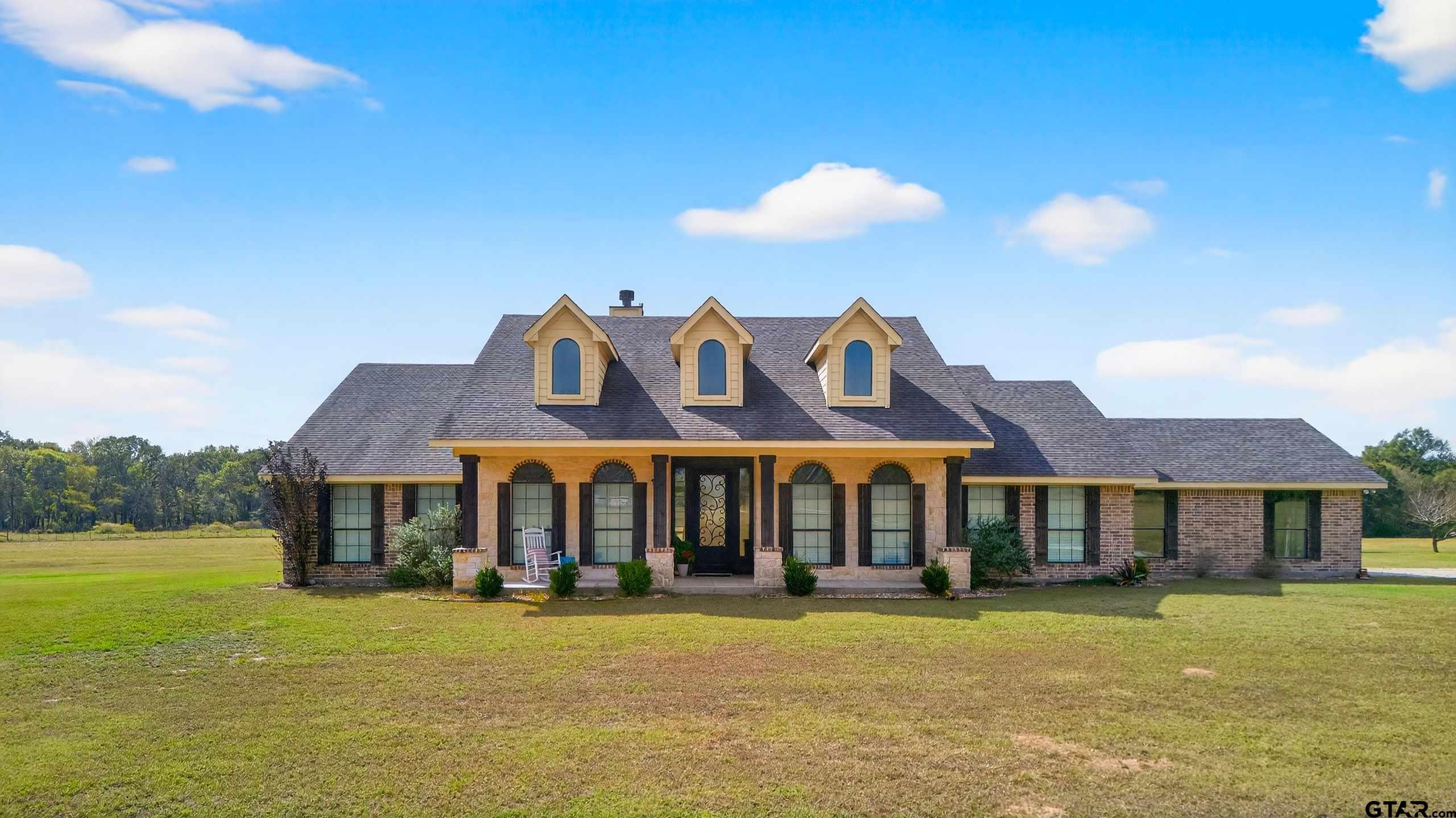 a front view of a house with swimming pool having outdoor seating
