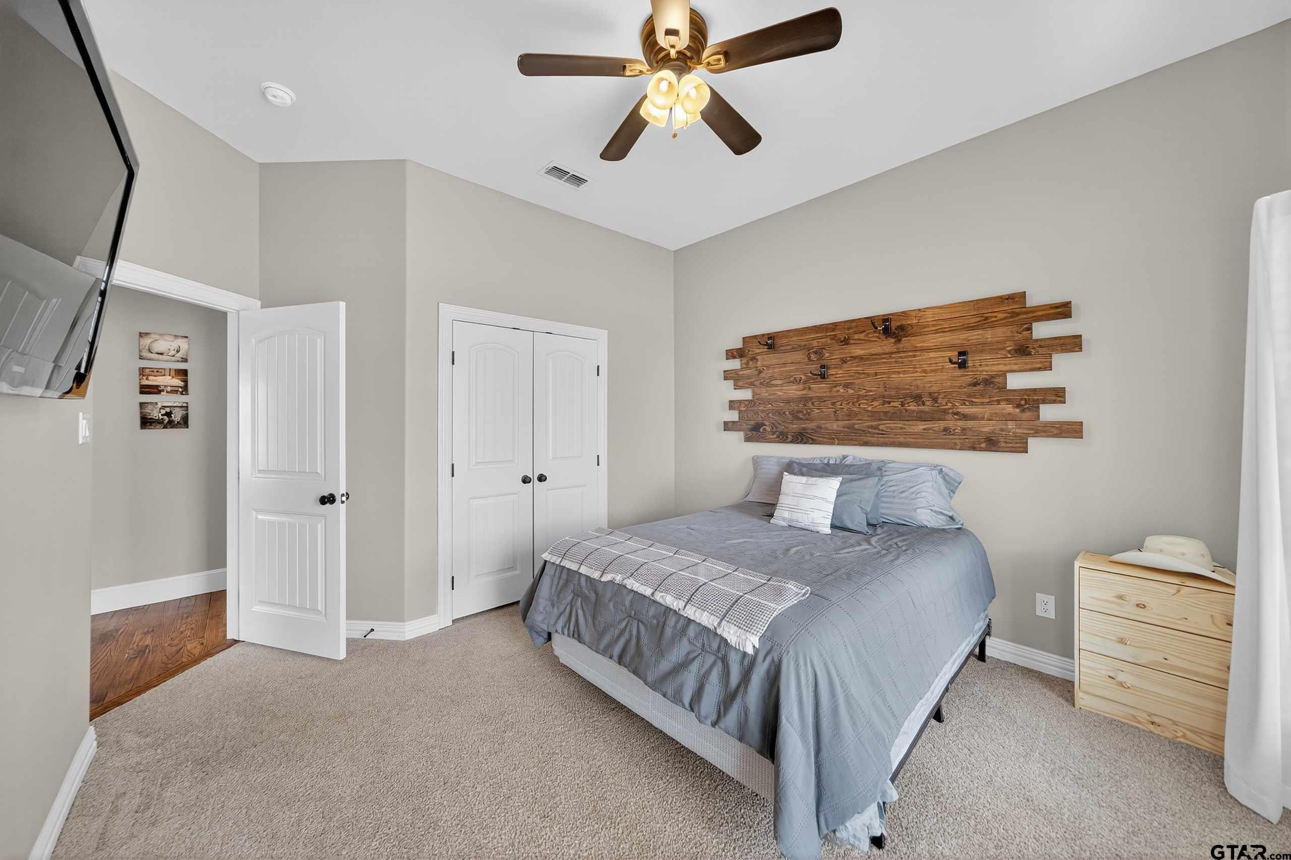 2621 Anderson County Road Palestine, TX 75803 - Photo 21 of 46 a bedroom with a bed and a painting on the wall