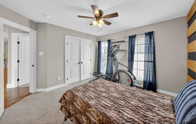 a bedroom with a bed dresser and a window