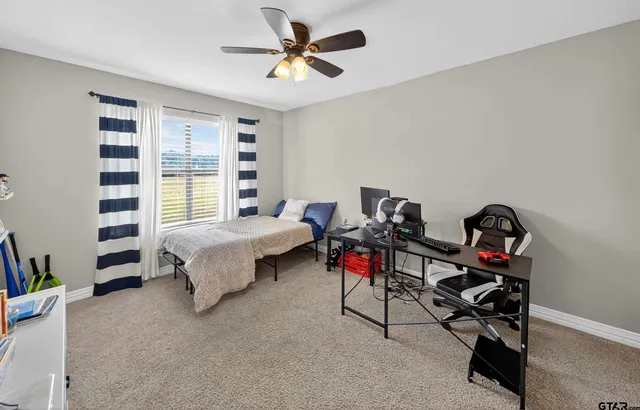 a bedroom with bed and a chandelier
