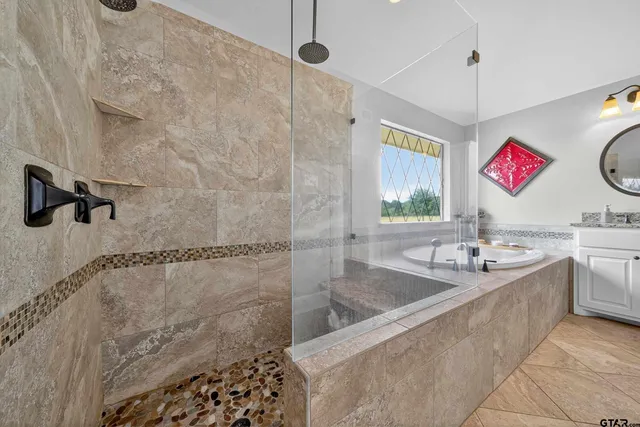 a bathroom with a granite countertop sink a bathtub and shower