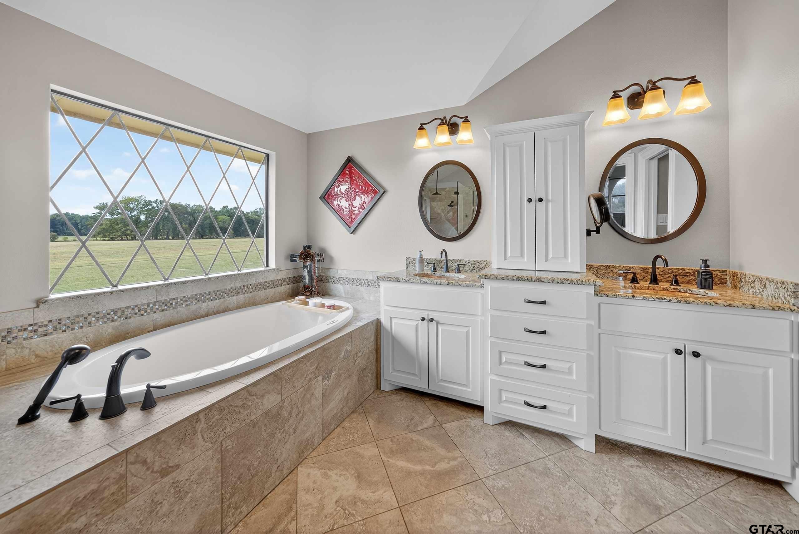 2621 Anderson County Road Palestine, TX 75803 - Photo 37 of 46 a bathroom with a tub sink and mirror