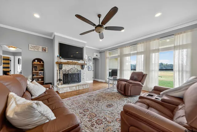 a living room with furniture a flat screen tv and a fireplace