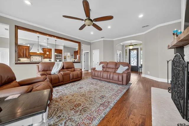 a living room with furniture ceiling fan and a rug