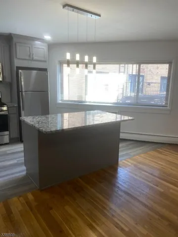 a kitchen with counter top space and windows