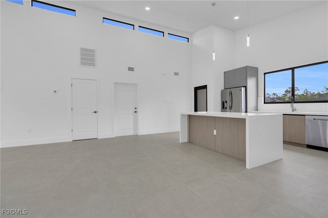 1011 State Avenue Lehigh Acres, FL 33972 - Photo 12 of 34 a view of a kitchen with a sink and cabinets