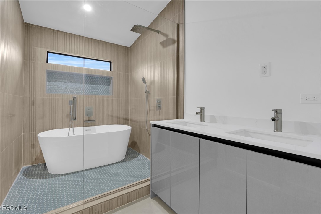 1011 State Avenue Lehigh Acres, FL 33972 - Photo 19 of 34 a bathroom with a sink and a mirror