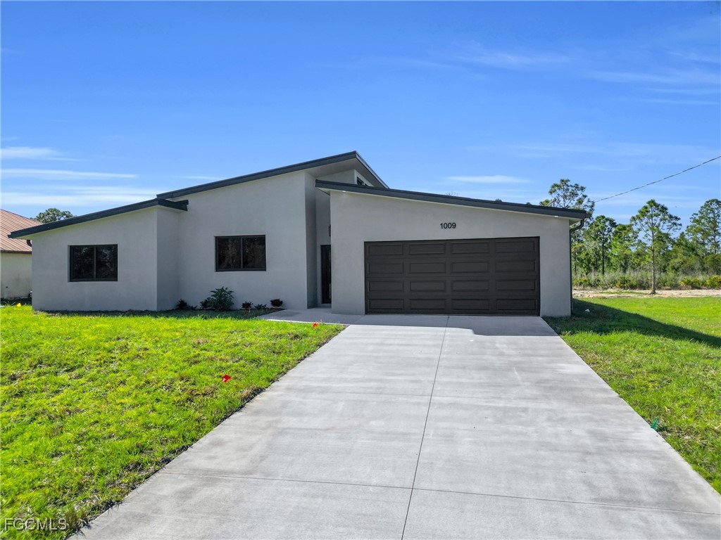 1011 State Avenue Lehigh Acres, FL 33972 - Photo 2 of 34 a front view of house with yard