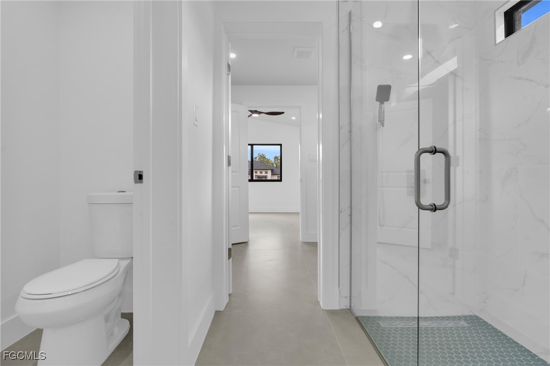 1011 State Avenue Lehigh Acres, FL 33972 - Photo 24 of 34 a bathroom with a shower and toilet