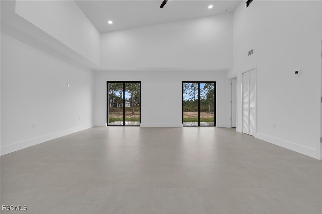 1011 State Avenue Lehigh Acres, FL 33972 - Photo 7 of 34 an empty room with windows and cabinet
