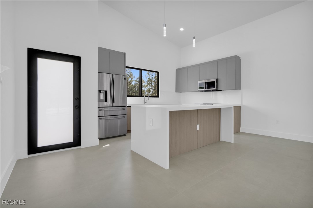 1011 State Avenue Lehigh Acres, FL 33972 - Photo 8 of 34 a view of kitchen with a sink a microwave and cabinets