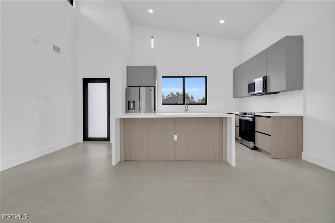1011 State Avenue Lehigh Acres, FL 33972 - Photo 9 of 34 a view of kitchen with stainless steel appliances cabinets
