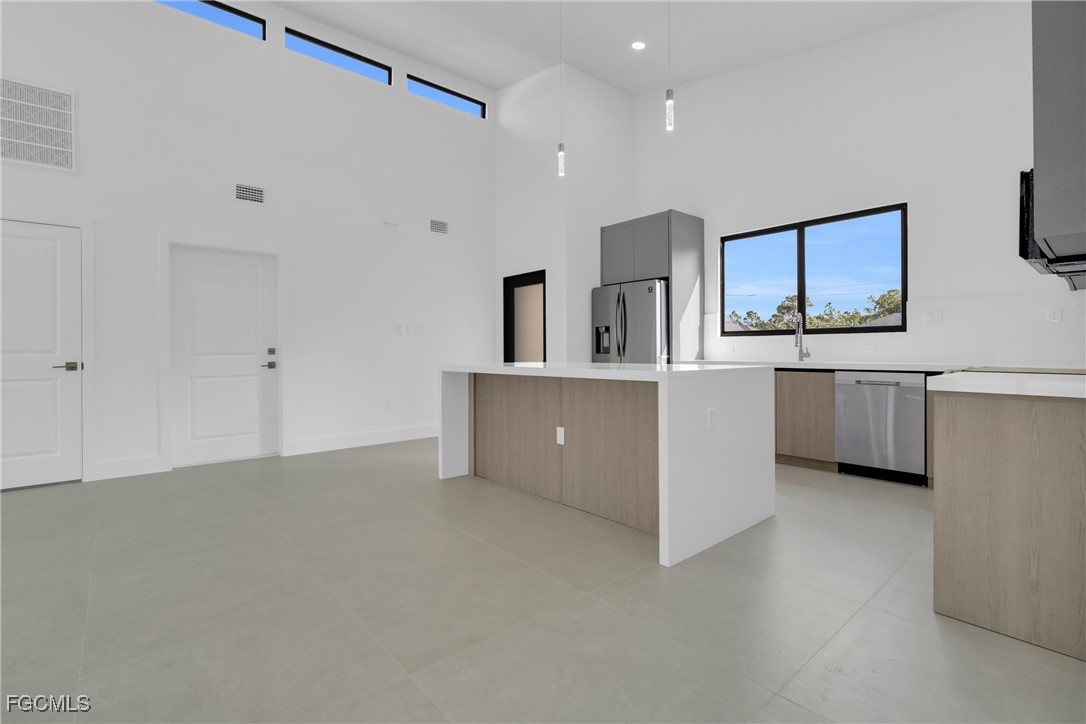 1011 State Avenue Lehigh Acres, FL 33972 - Photo 10 of 34 a view of a kitchen with furniture and an empty room
