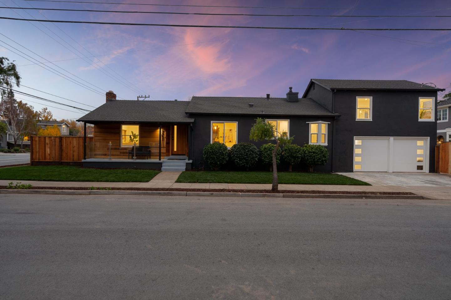a front view of a house with a yard and a garage