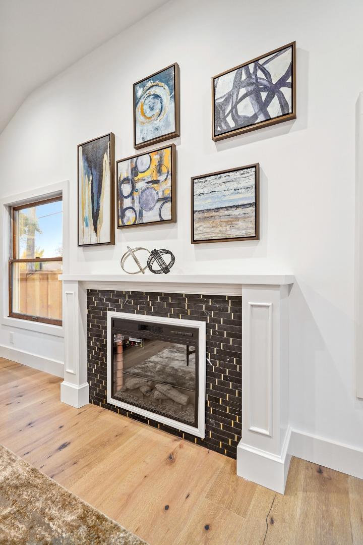 201 Channing Road Burlingame, CA 94010 - Photo 12 of 52 a living room with wall painting and a fireplace