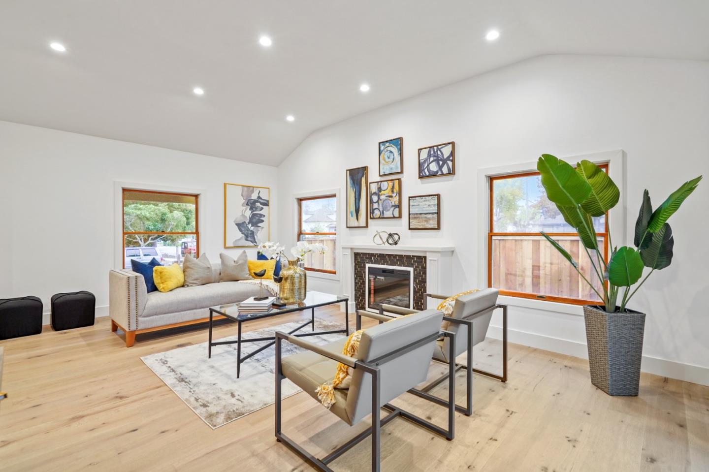 201 Channing Road Burlingame, CA 94010 - Photo 9 of 52 a living room with furniture a potted plant and a fireplace