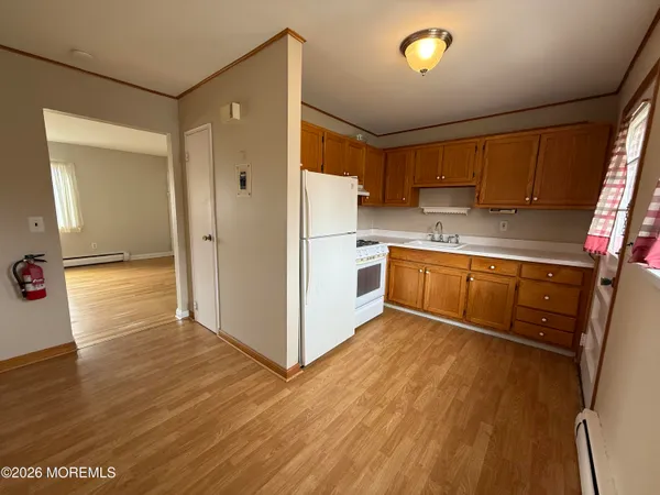 a kitchen with a refrigerator sink and cabinets