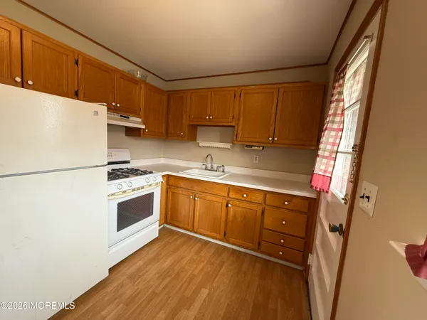 a kitchen with a white cabinets and white appliances