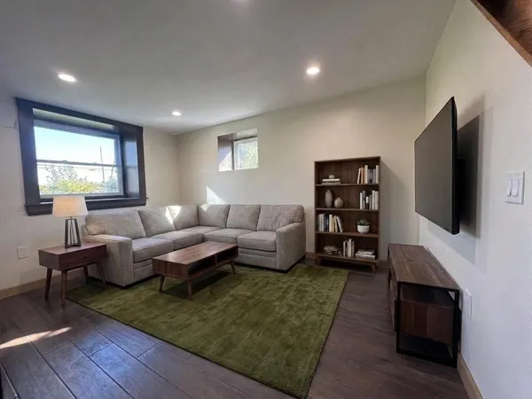 a living room with fireplace furniture and a flat screen tv