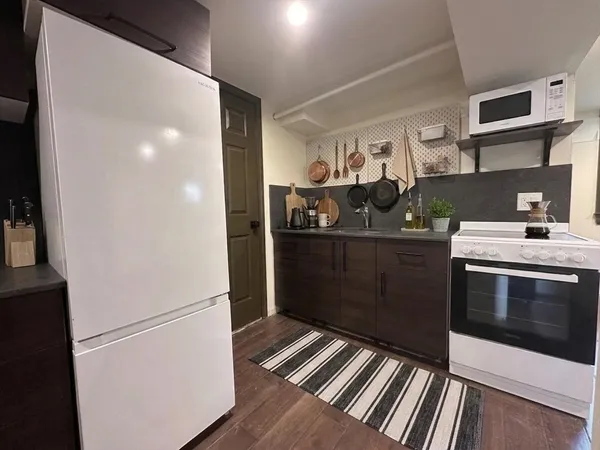 a kitchen with stainless steel appliances granite countertop a refrigerator and a sink