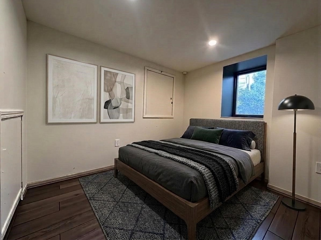 64 Goodenough Street, Unit G Boston, MA 02135 - Photo 5 of 6 a bedroom with a bed lamp and window