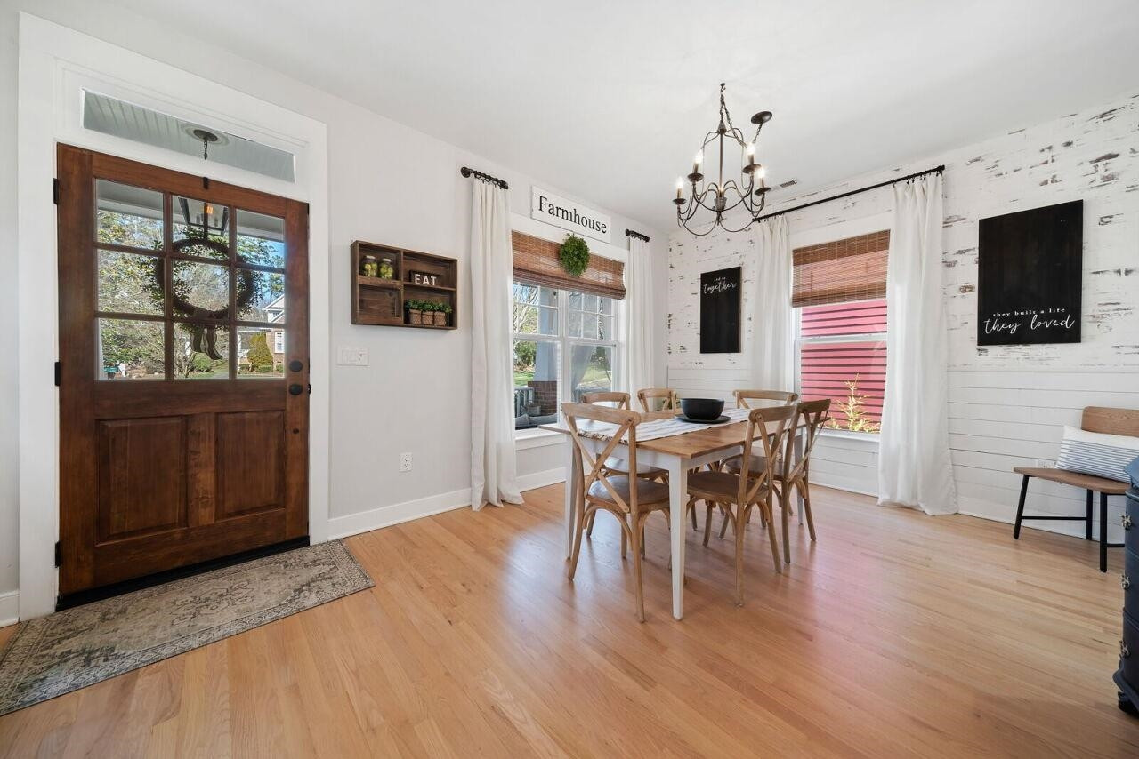 4417 All Points View Way Raleigh, NC 27614 - Photo 7 of 34 a dining room with wooden floor a chandelier a wooden table and chairs