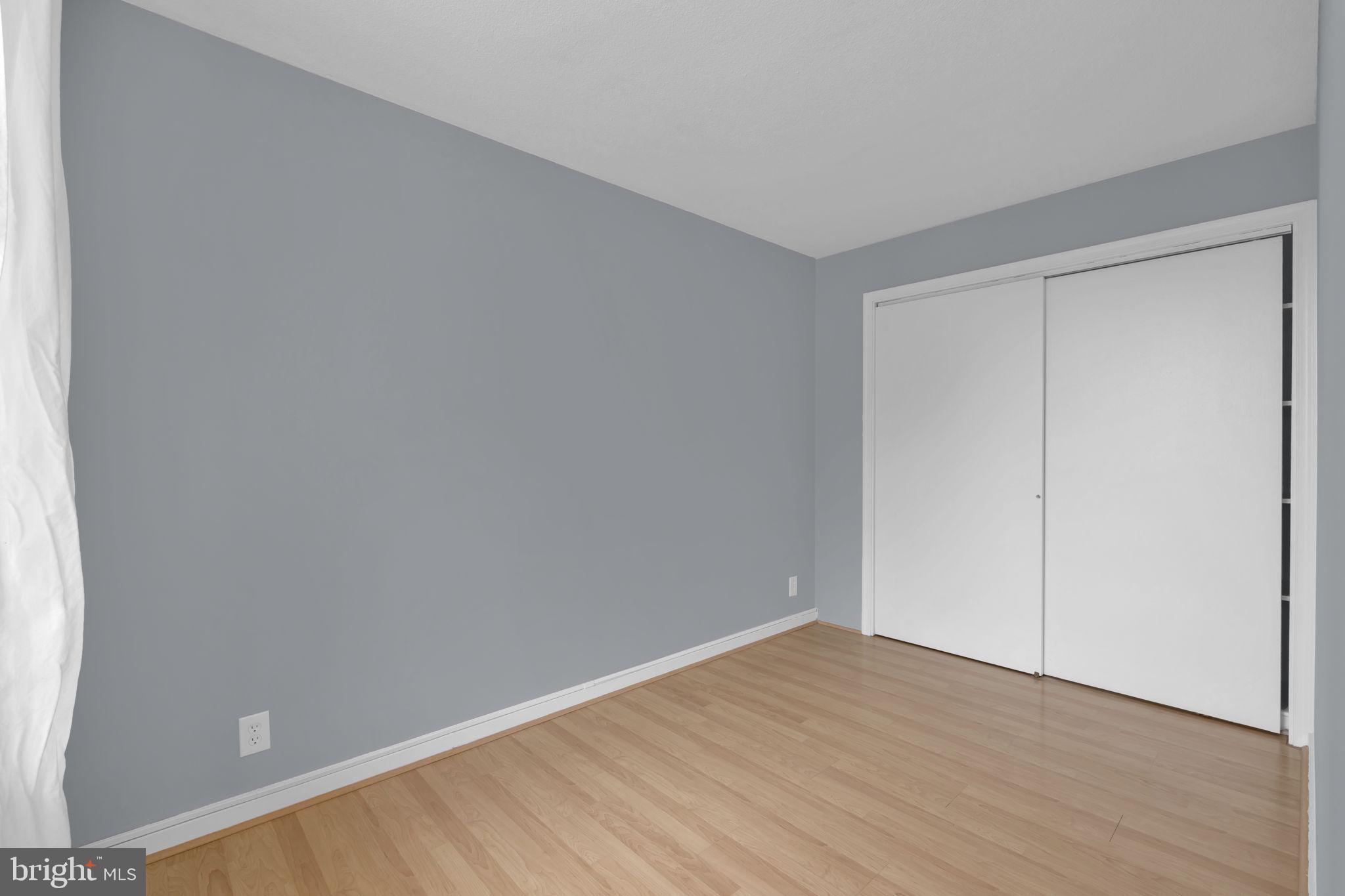 1245 4th Street Southwest, Unit E210 Washington, DC 20024 - Photo 10 of 28 a view of an empty room with wooden floor