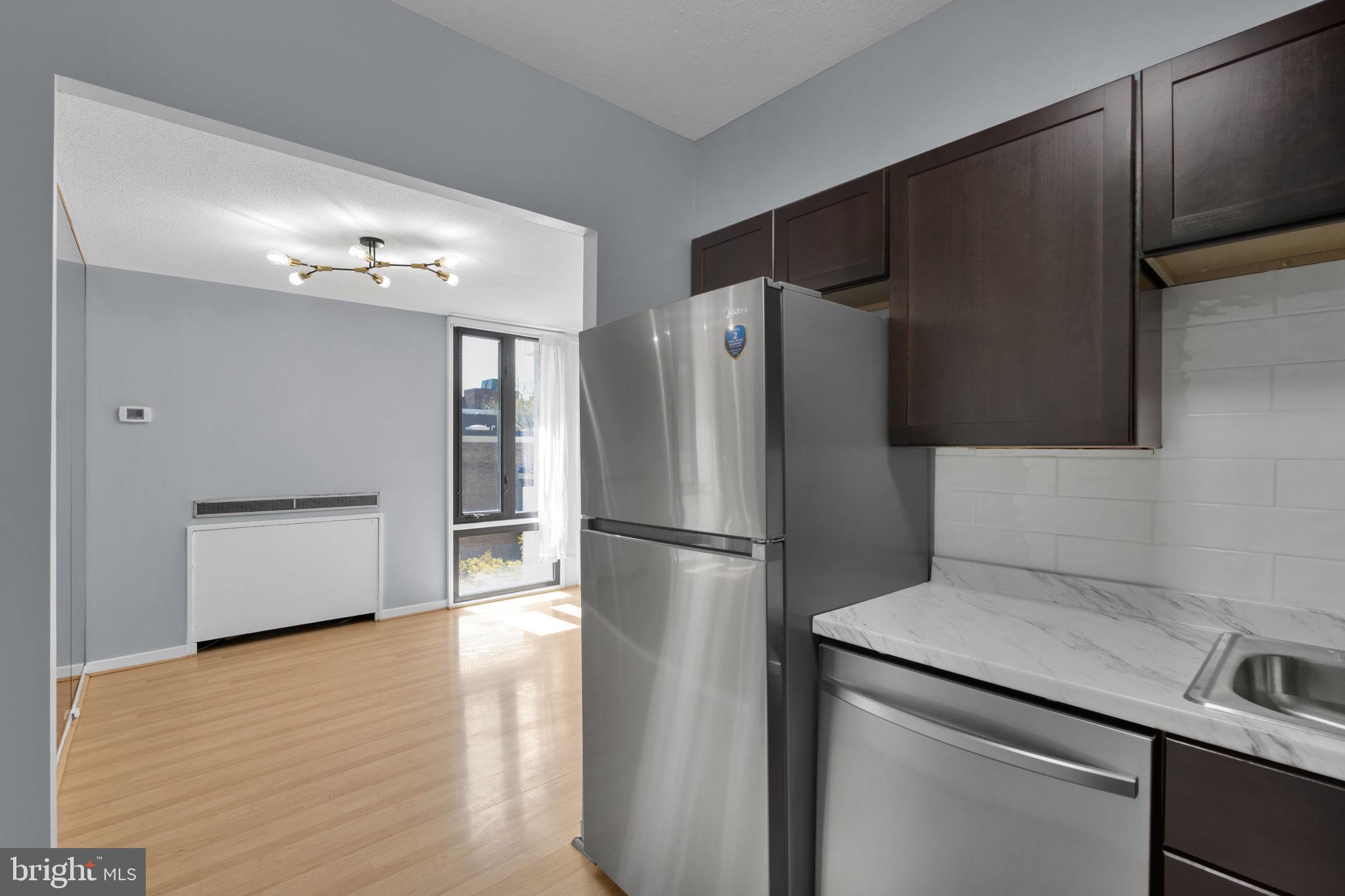 1245 4th Street Southwest, Unit E210 Washington, DC 20024 - Photo 14 of 28 a kitchen with stainless steel appliances a refrigerator and a sink