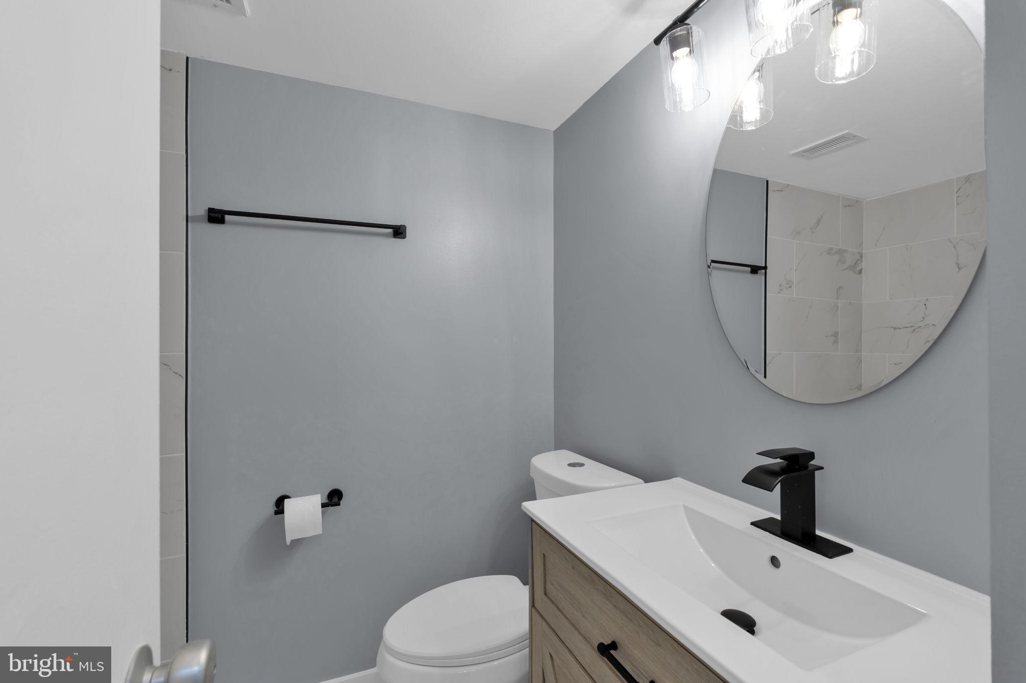 1245 4th Street Southwest, Unit E210 Washington, DC 20024 - Photo 15 of 28 a bathroom with a sink mirror and toilet