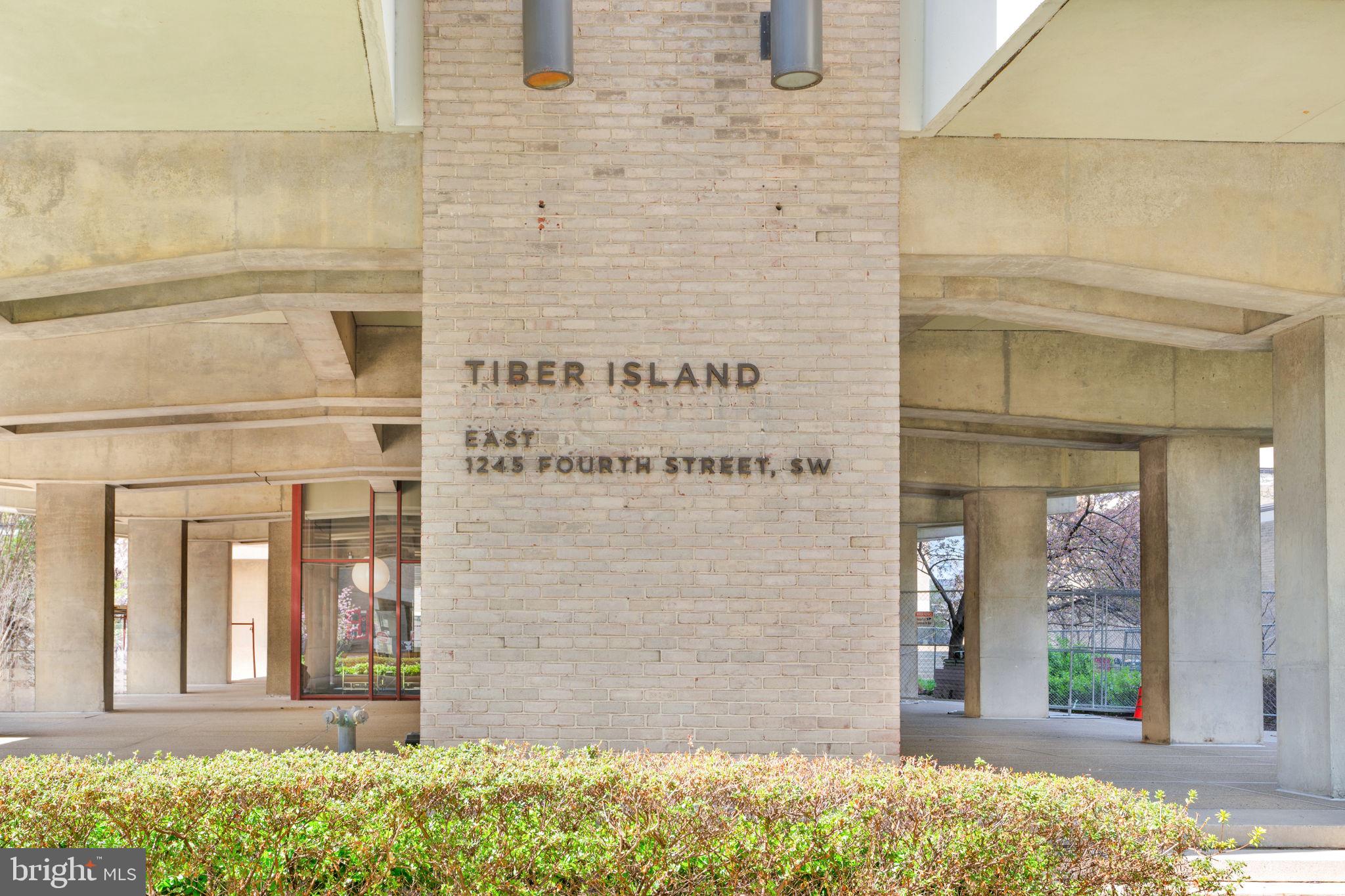 1245 4th Street Southwest, Unit E210 Washington, DC 20024 - Photo 2 of 28 a front view of a building with a garden