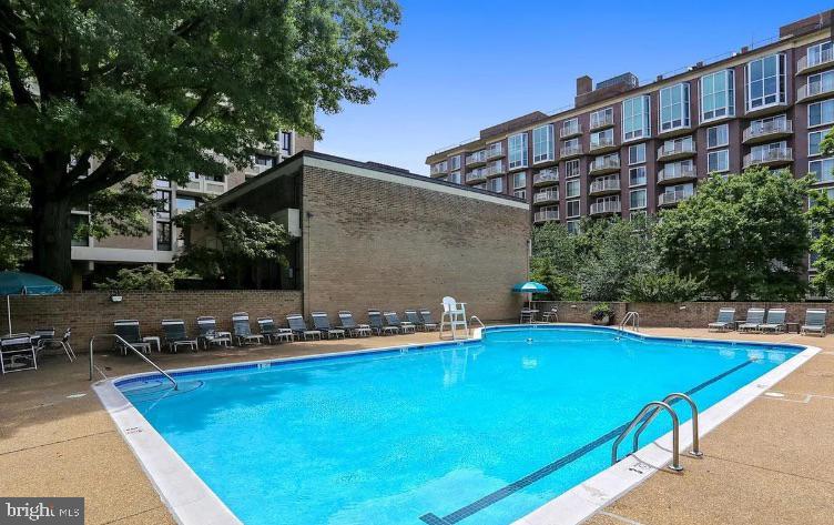 1245 4th Street Southwest, Unit E210 Washington, DC 20024 - Photo 21 of 28 a view of swimming pool with outdoor seating and plants