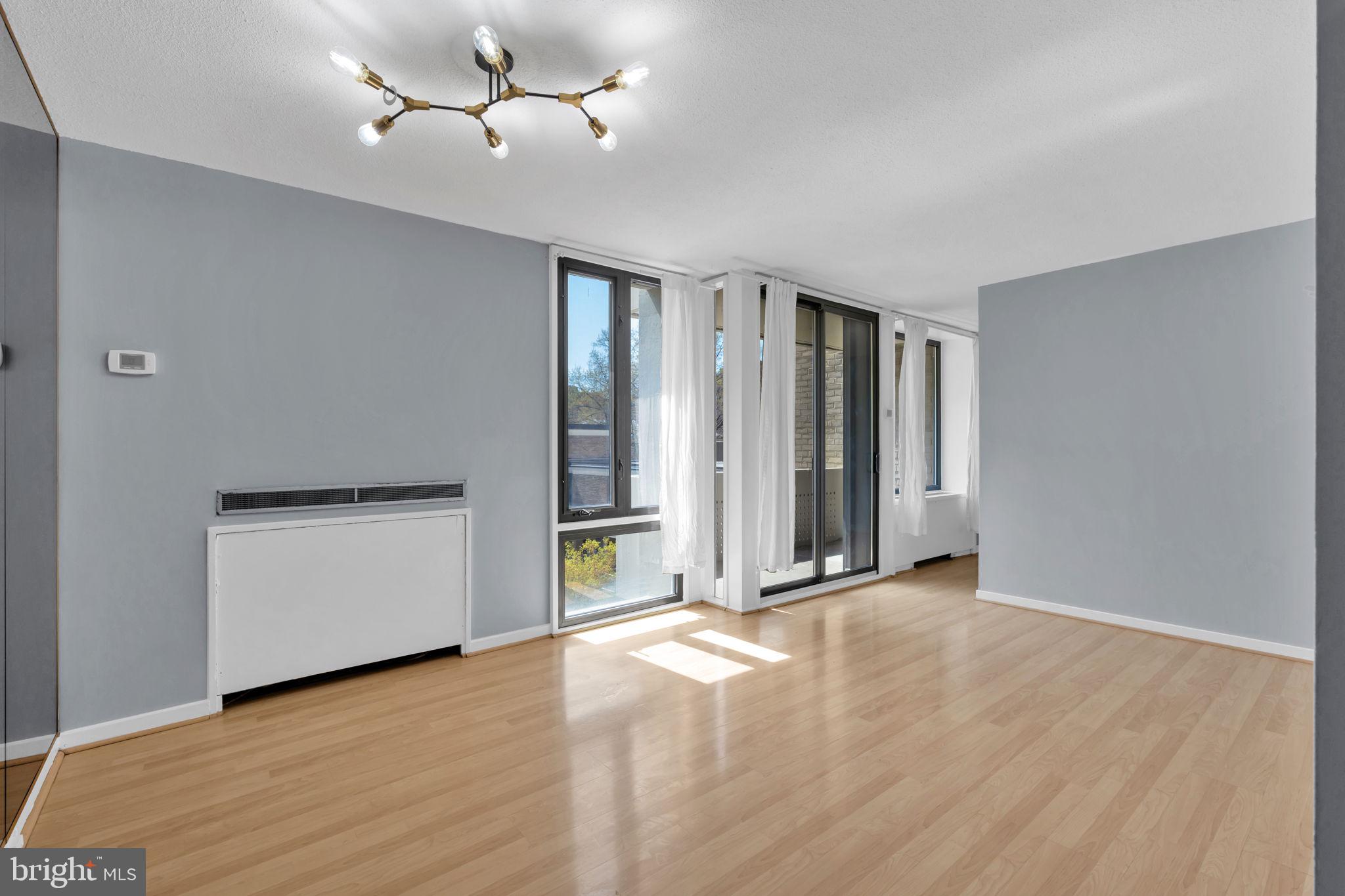 1245 4th Street Southwest, Unit E210 Washington, DC 20024 - Photo 6 of 28 wooden floor in an empty room with a window